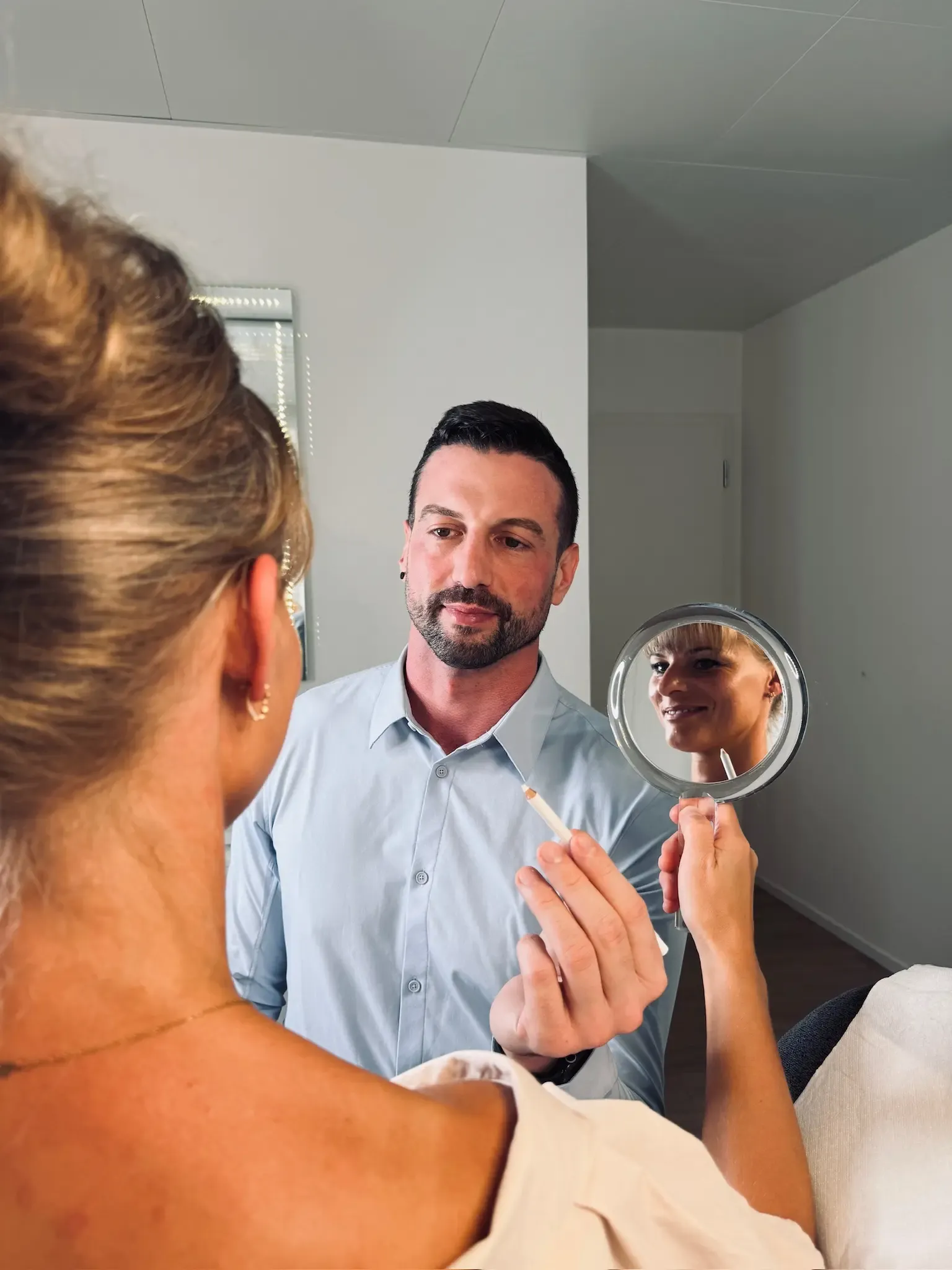 Dr. Scheffbuch assessing a patient's face